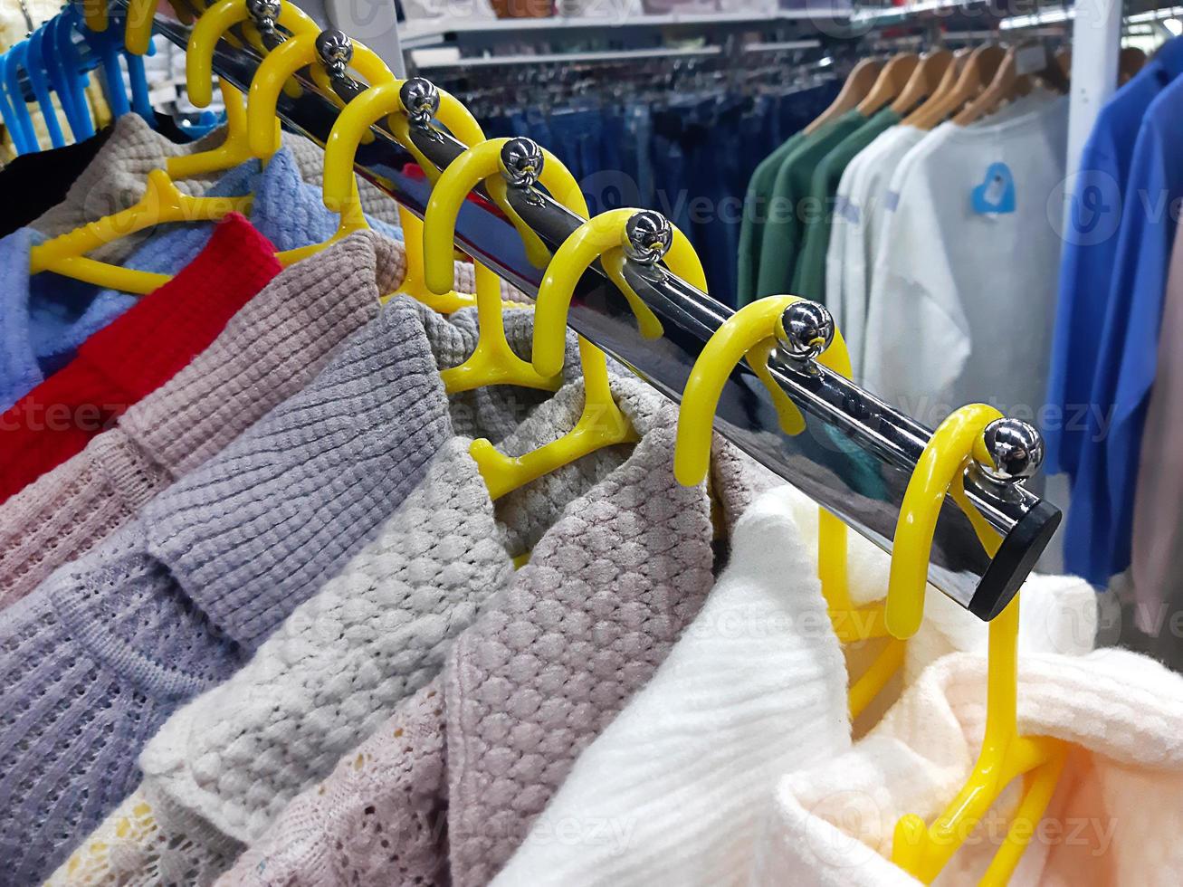 hangers-in-the-store-with-clothes-hang-on-the-window-in-a-row-women-s-clothing-fashion-shopping-photo